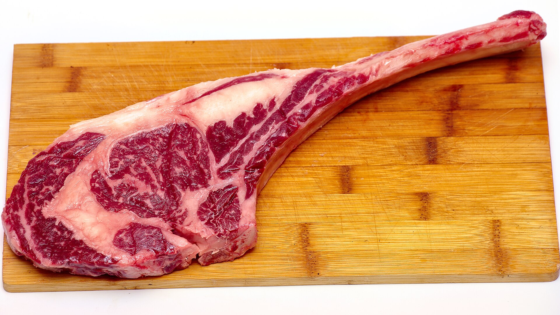 Aged tomahawk rib of beef on a board